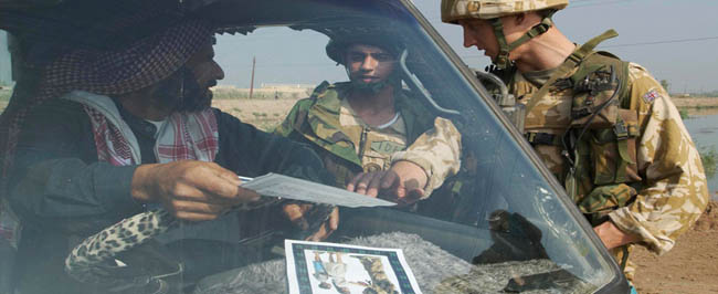 Iraq: British soldiers handing out information leaflets.